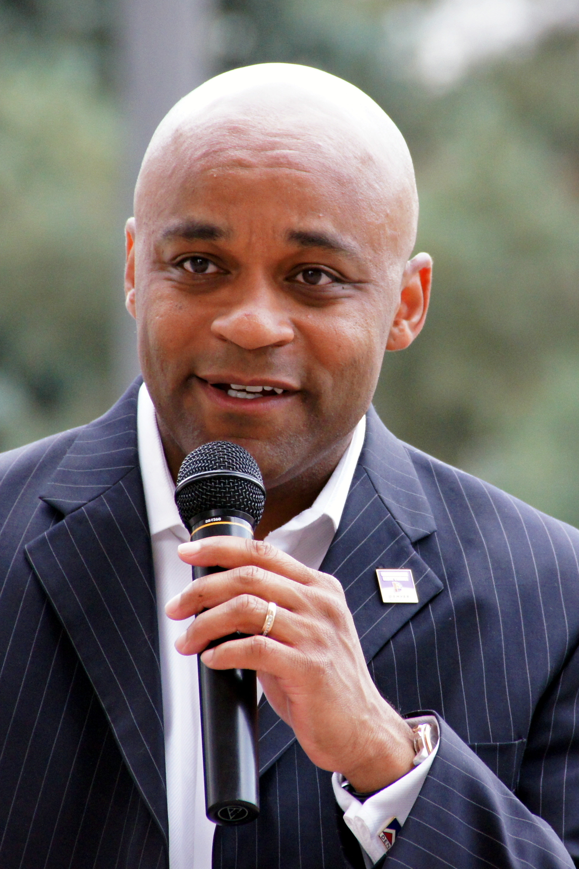 "Denver Mayor Michael Hancock - 2012-08-15 (portrait crop)" by Original by Mike Johnston is licensed under CC BY 2.0.