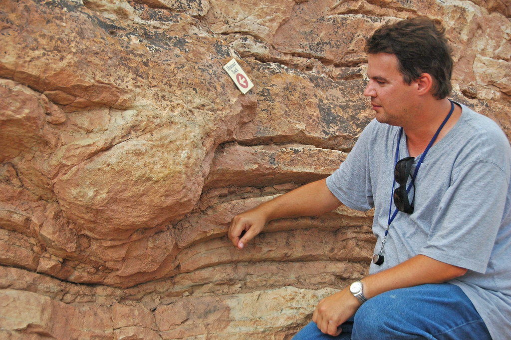 "Sauropod dinosaur footprint bulge in sandstone (upper Morrison Formation, Upper Jurassic; Dinosaur Ridge, west of Denver, Colorado, USA)" by James St. John is licensed under CC BY 2.0.