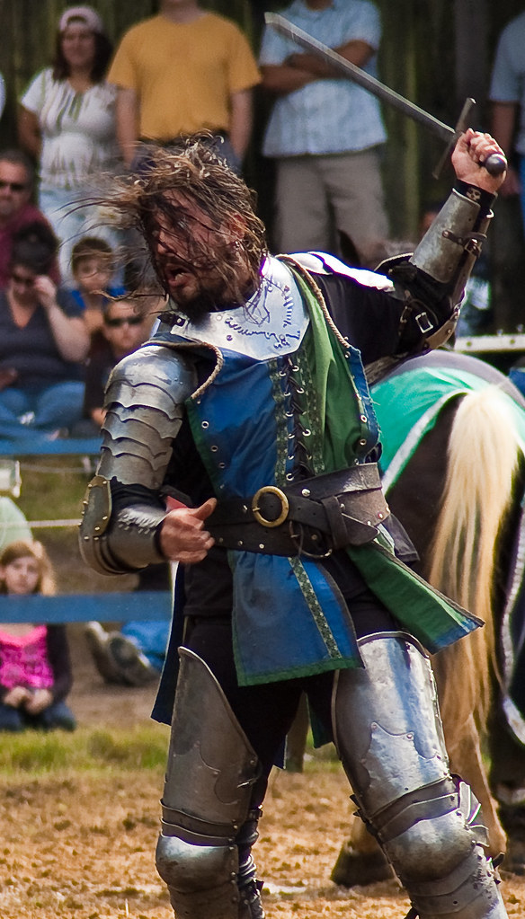 Armored knights on horseback charge with lances during the jousting tournament