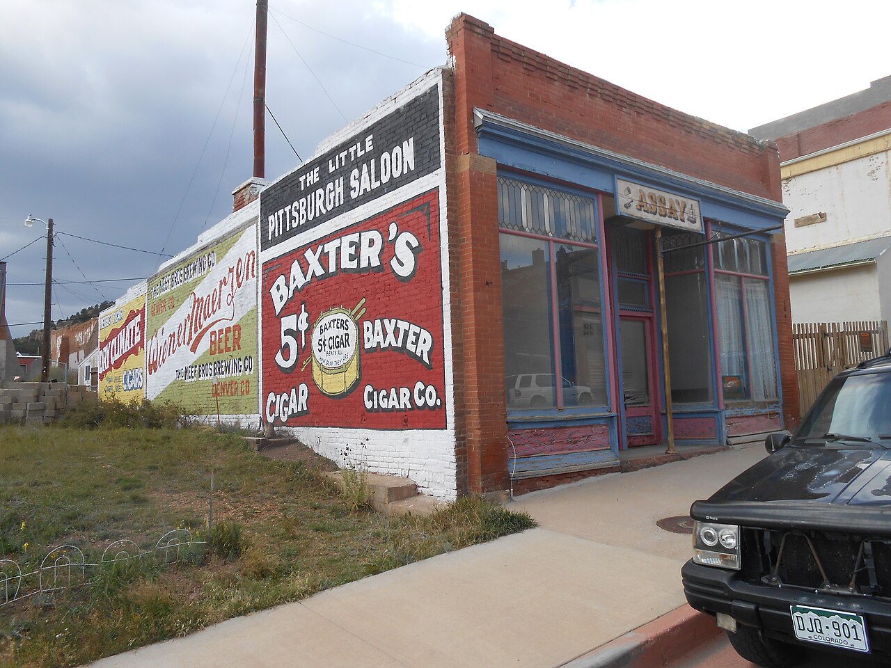 Weathered brick storefronts and headframes line the historic mining district's quiet streets