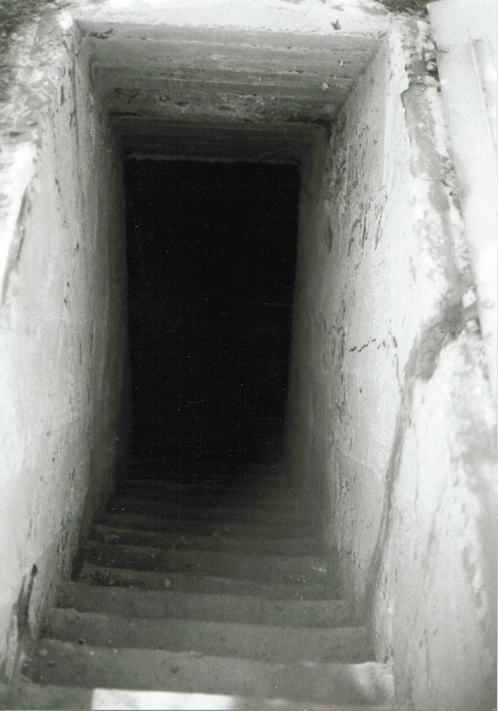 "View looking down into the cellar coffin of the Death Pit, The Ludlow Massacre Memorial, April 20th, 1914, Colorado Massacre on Striking Coal Miners" by Beverly & Pack is licensed under CC BY 2.0.