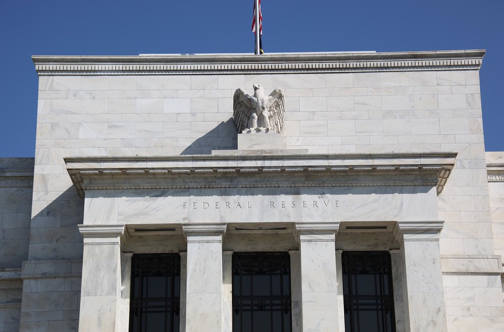 "Federal Reserve Building - front with flag - 2012-09-13" by Tim Evanson is licensed under CC BY-SA 2.0.